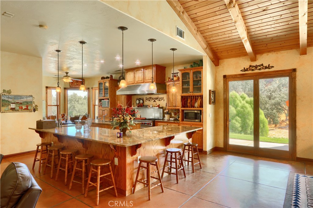 1087 Ben Hur Road Raymond, CA 93653 - Photo 3 of 75 a large kitchen with a table and chairs