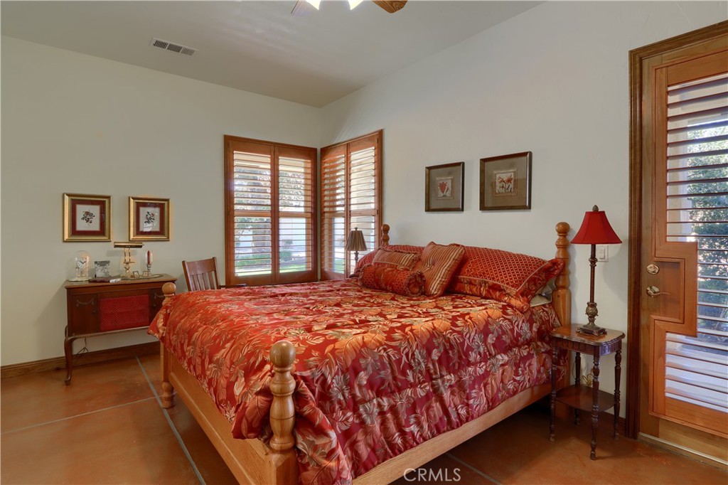 1087 Ben Hur Road Raymond, CA 93653 - Photo 32 of 75 a bedroom with a bed and a dresser next to a window