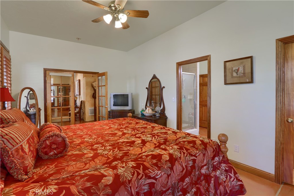 1087 Ben Hur Road Raymond, CA 93653 - Photo 33 of 75 a bed sitting in a bedroom and a large mirror