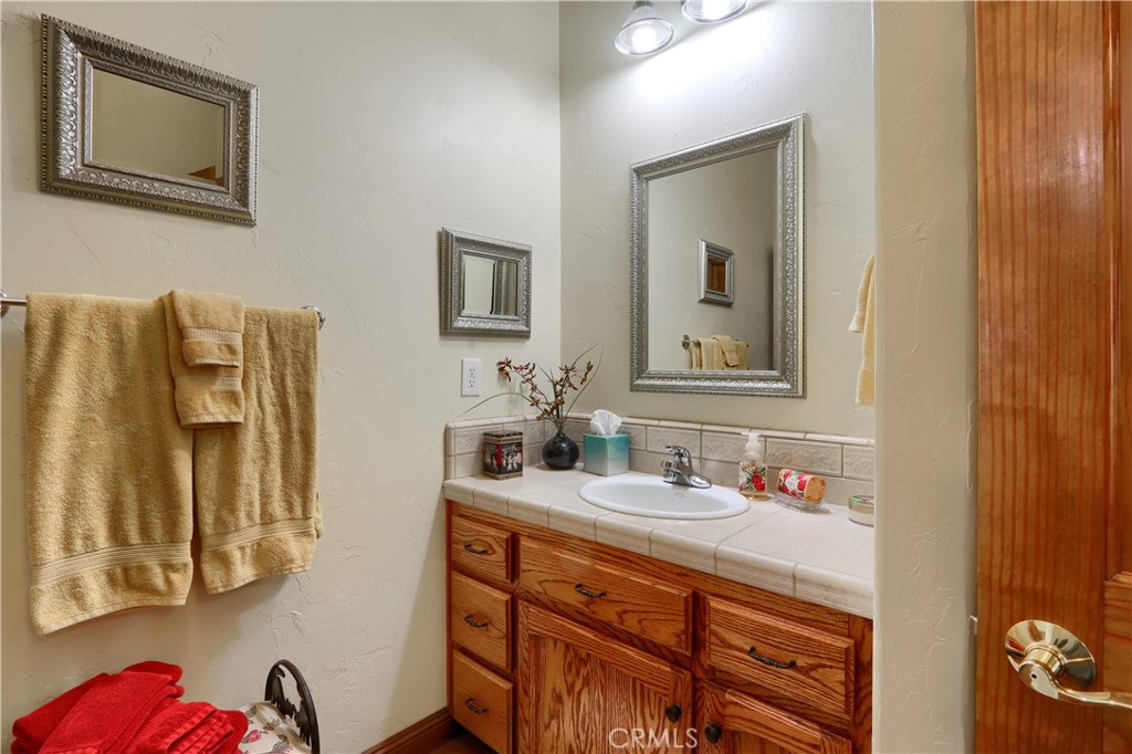 1087 Ben Hur Road Raymond, CA 93653 - Photo 34 of 75 a bathroom with a sink and a mirror
