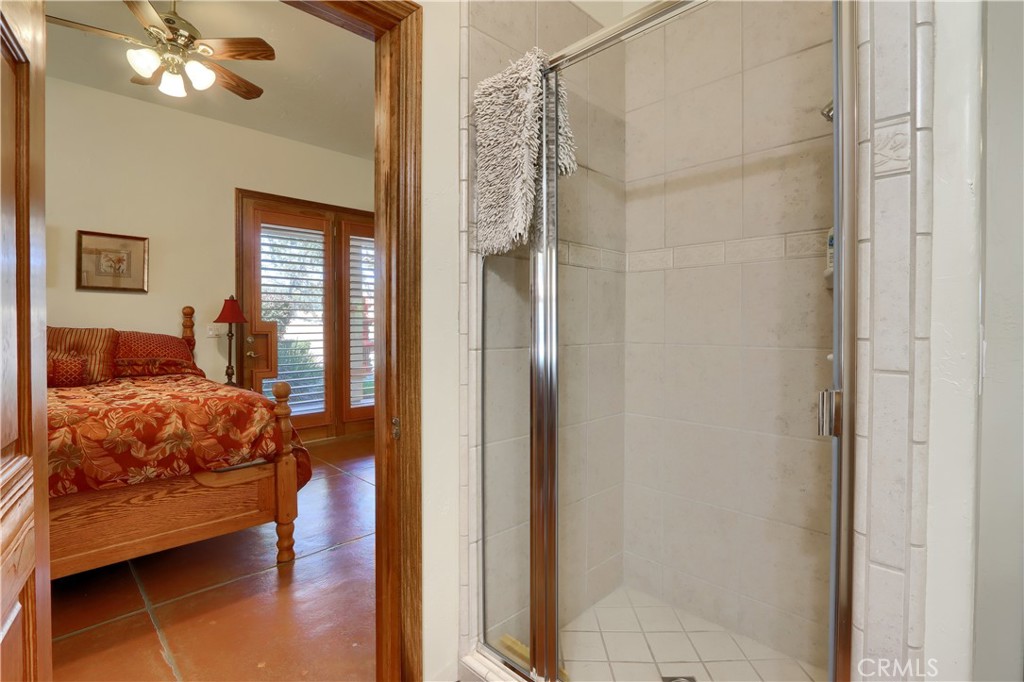 1087 Ben Hur Road Raymond, CA 93653 - Photo 35 of 75 a bedroom with a bed and a chandelier