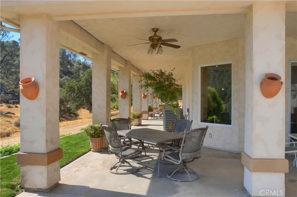 1087 Ben Hur Road Raymond, CA 93653 - Photo 45 of 75 a view of a patio with table and chairs and potted plants