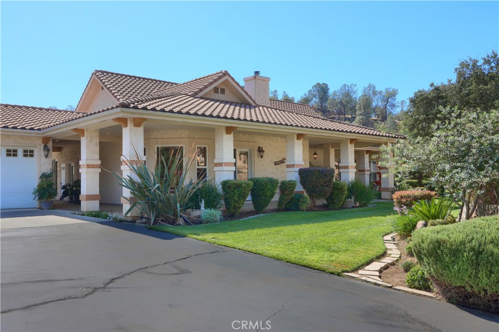 1087 Ben Hur Road Raymond, CA 93653 - Photo 48 of 75 a front view of a house with a yard and potted plants
