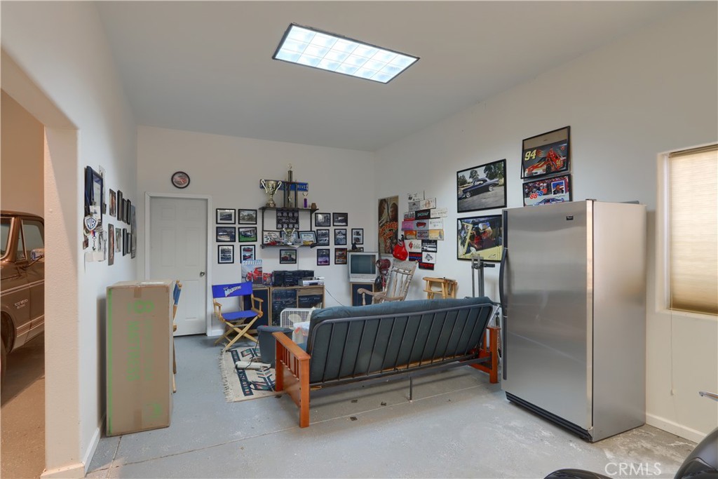 1087 Ben Hur Road Raymond, CA 93653 - Photo 62 of 75 a bedroom with furniture and a refrigerator