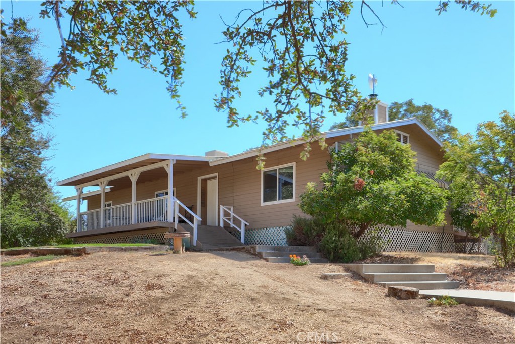 1087 Ben Hur Road Raymond, CA 93653 - Photo 66 of 75 a front view of a house with a yard and garage