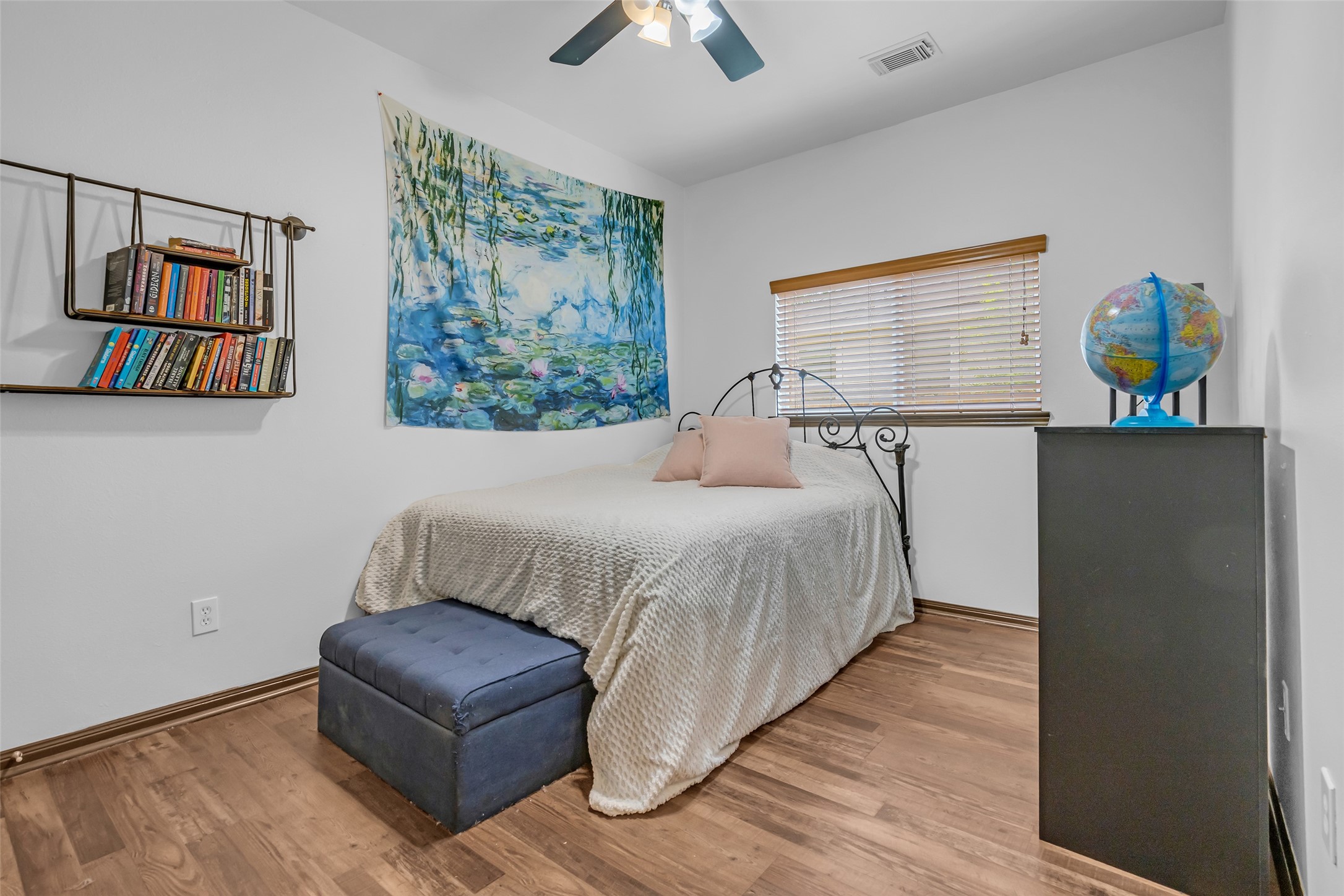 134 South Star Ridge Circle The Woodlands, TX 77382 - Photo 20 of 29 a bedroom with a bed and a chandelier