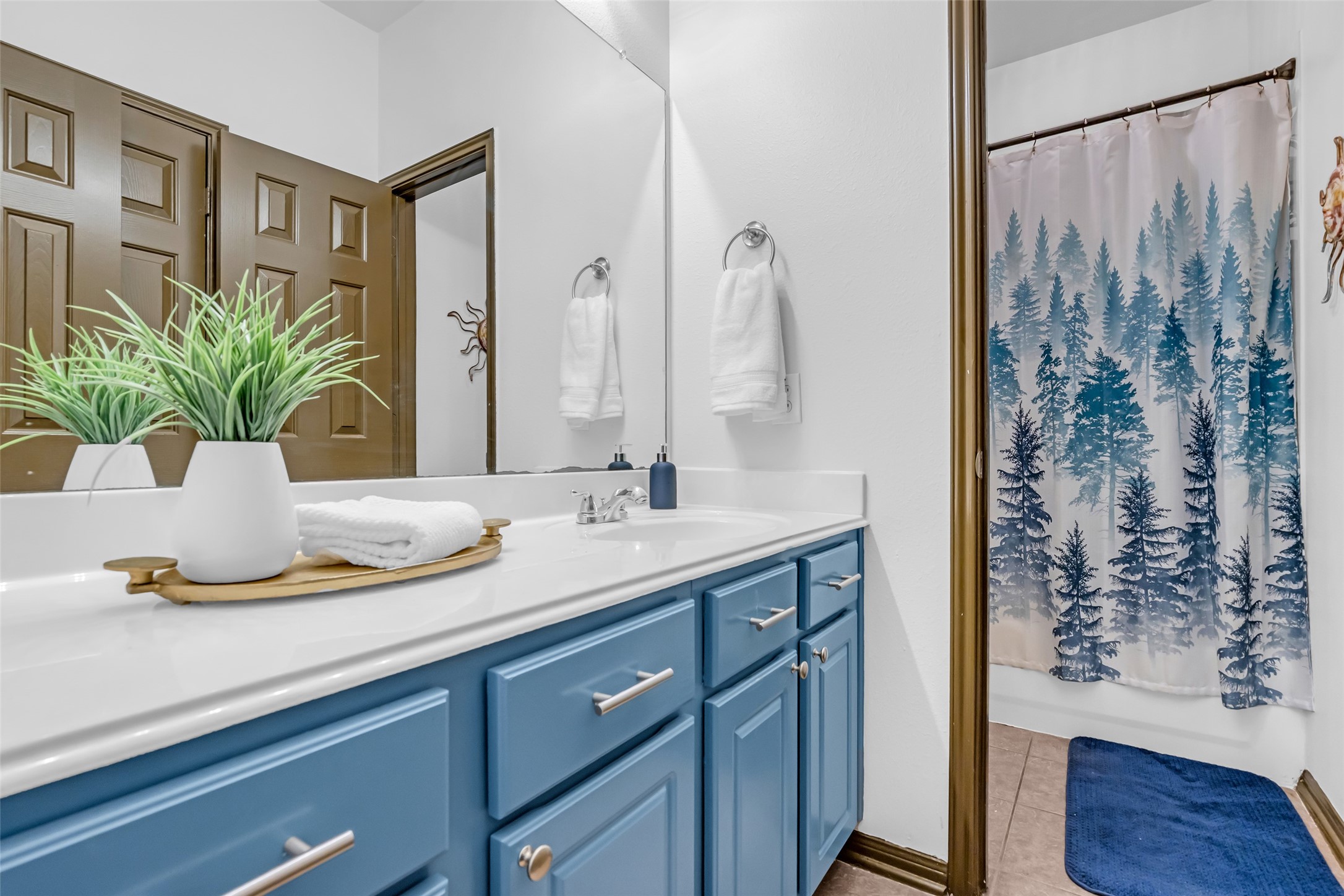 134 South Star Ridge Circle The Woodlands, TX 77382 - Photo 21 of 29 a bathroom with a granite countertop sink a mirror and a shower