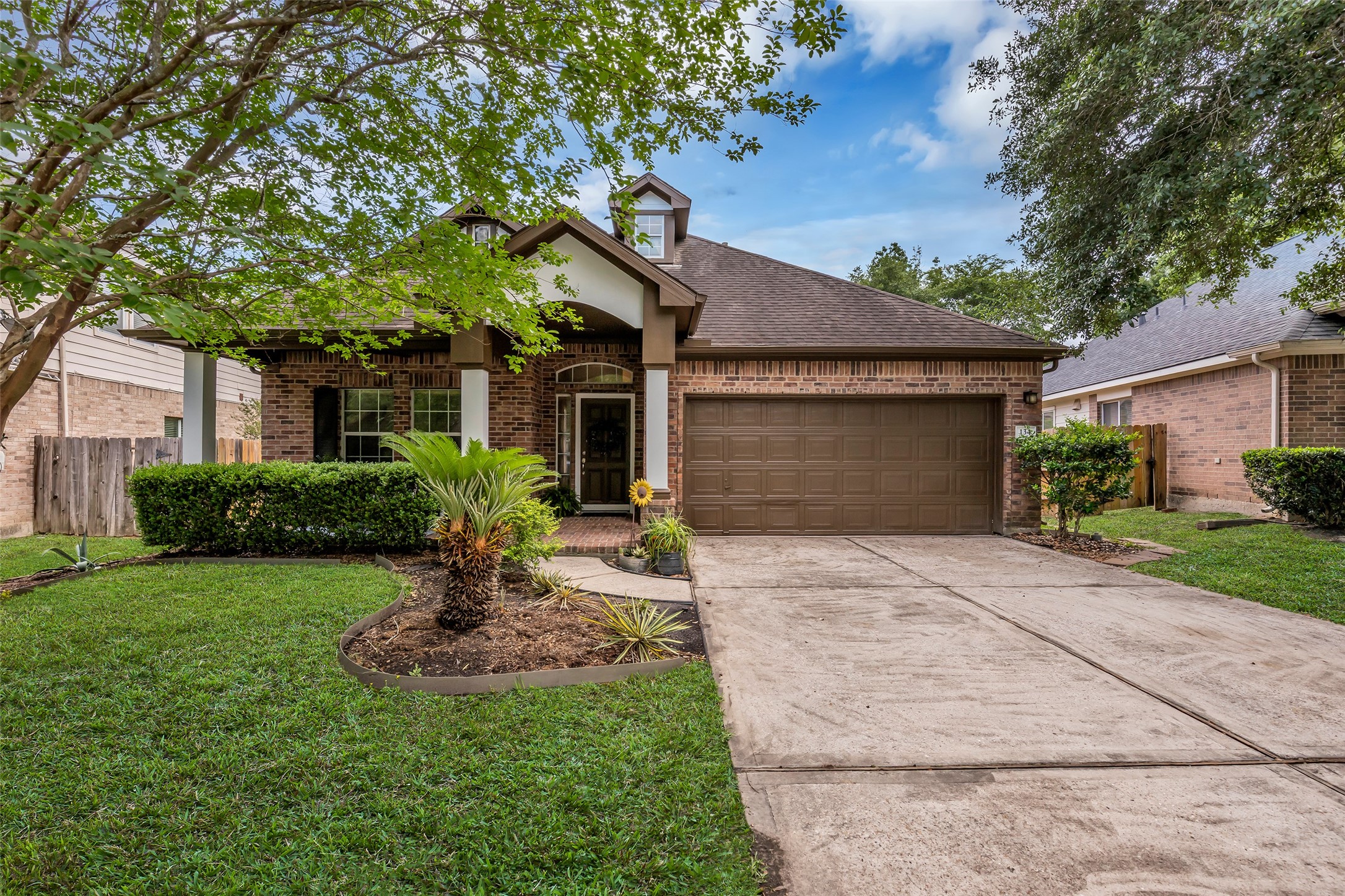 134 South Star Ridge Circle The Woodlands, TX 77382 - Photo 3 of 29 a front view of a house with garden