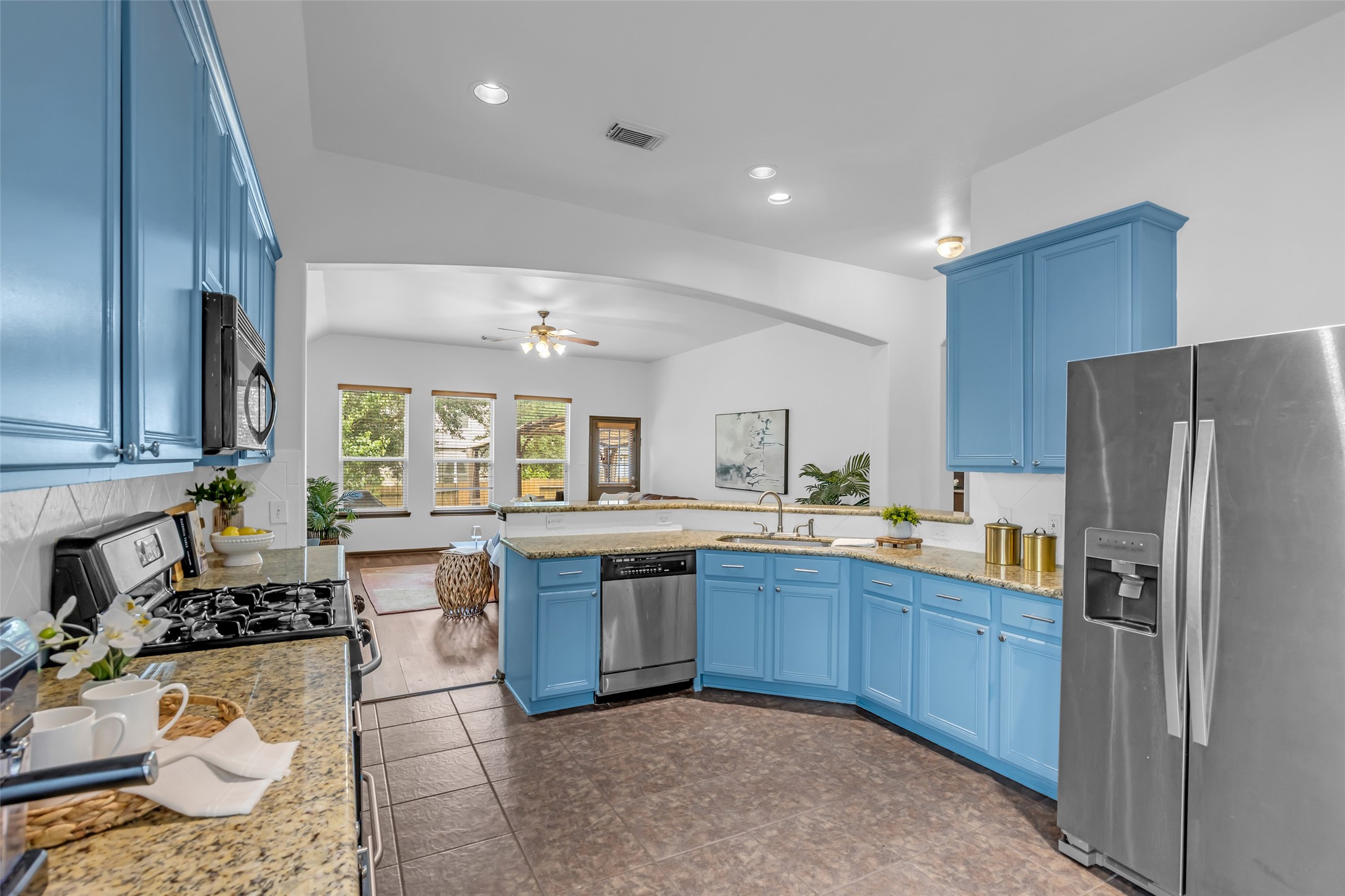 134 South Star Ridge Circle The Woodlands, TX 77382 - Photo 7 of 29 a kitchen with granite countertop stainless steel appliances and wooden cabinets