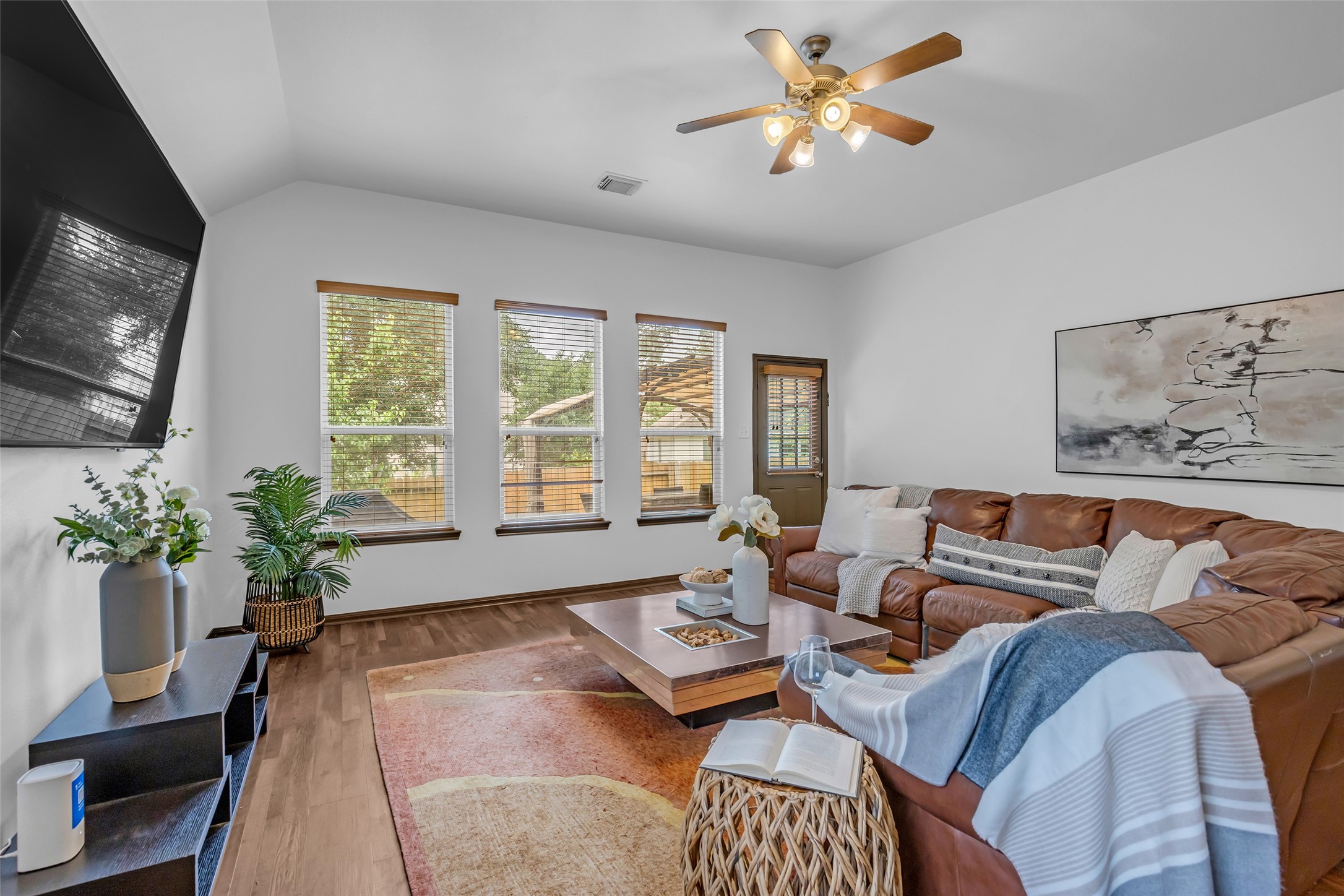 134 South Star Ridge Circle The Woodlands, TX 77382 - Photo 9 of 29 a living room with furniture ceiling fan and a flat screen tv