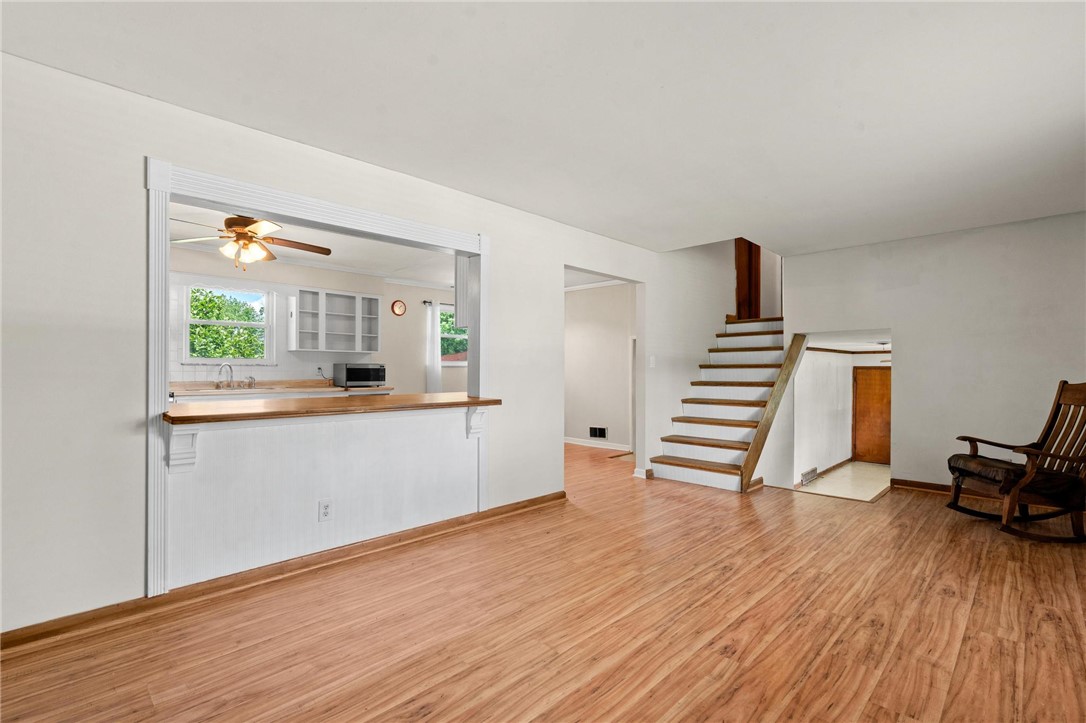 4150 Rose Marie Road Franklin, OH 45005 - Photo 18 of 36 An inviting open-concept living space features warm hardwood flooring, connecting to a functional kitchen with a convenient pass-through.