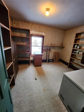 a view of hallway with stairs and wooden floor