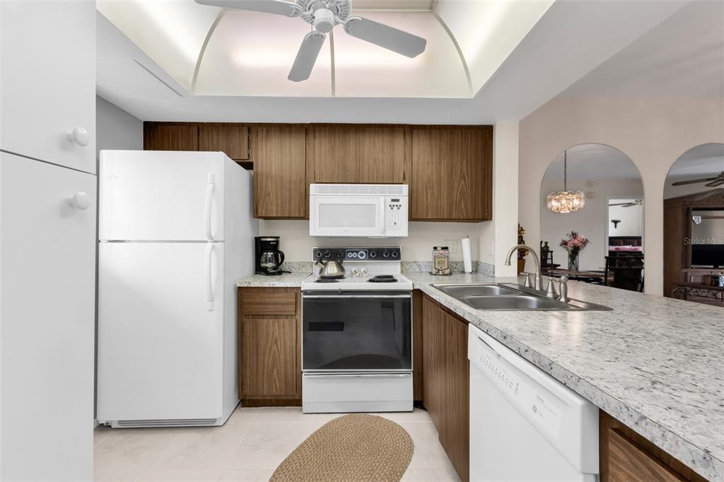 25225 Rampart Boulevard, Unit 1604 Punta Gorda, FL 33983 - Photo 13 of 41 a kitchen with stainless steel appliances granite countertop a sink stove and refrigerator