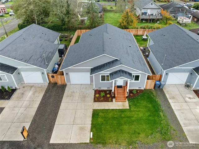 an aerial view of a house with a yard