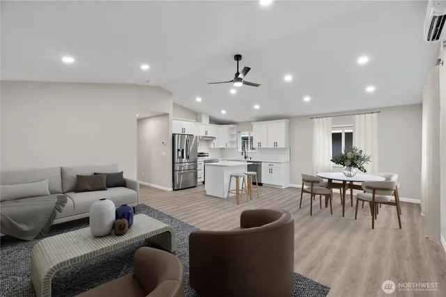 a living room with lots of furniture and kitchen view