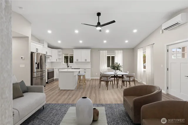 a living room with furniture and kitchen view