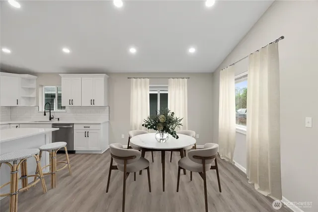 a view of a dining room with furniture and wooden floor