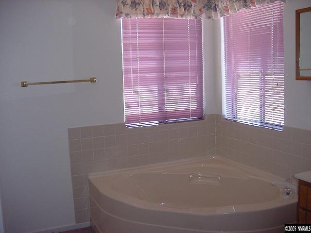 5301 Simons Drive Reno, NV 89523 - Photo 8 of 8 a bath tub sitting in a bathroom next to a window