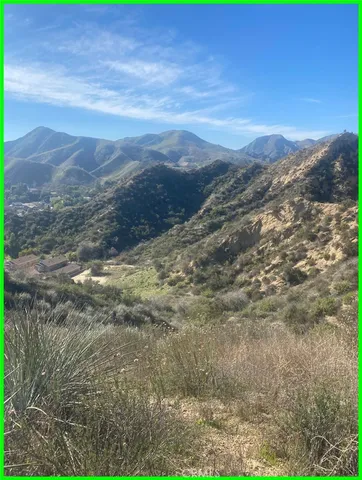 a view of a big yard with space and wooden fence
