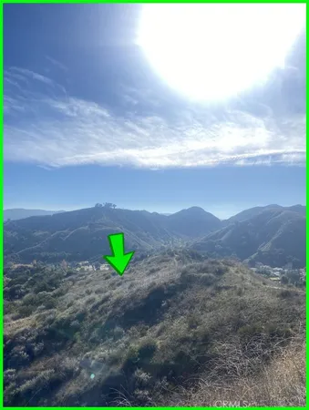 a view of a field with mountains in the background