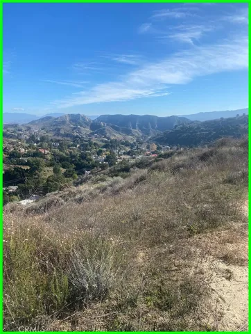 a view of a field with an ocean