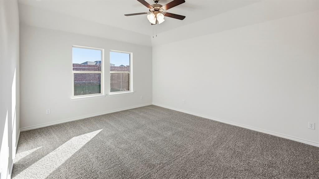 403 Flintlock Road Caddo Mills, TX 75135 - Photo 15 of 26 Carpeted empty room featuring baseboards and ceiling fan