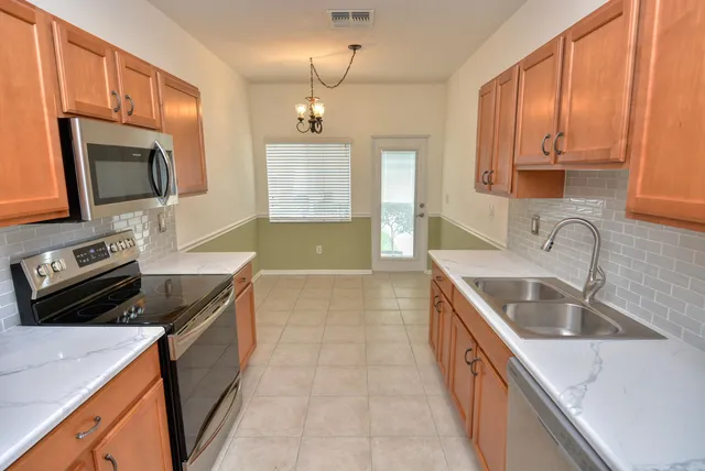 a kitchen with a sink stove and microwave