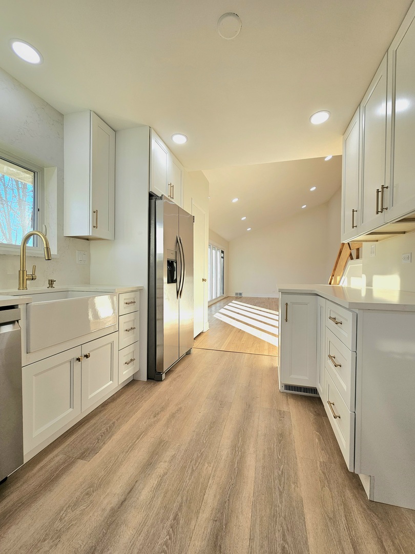 7434 Emerson Street Morton Grove, IL 60053 - Photo 11 of 43 a kitchen with stainless steel appliances a refrigerator sink and cabinets