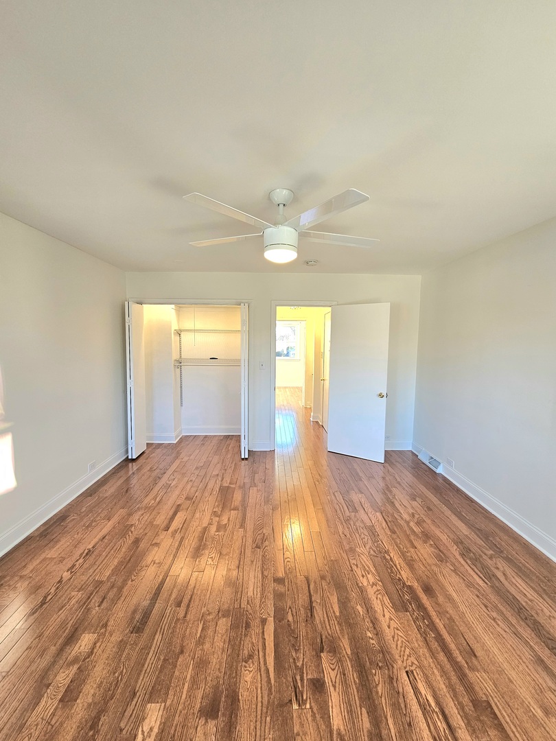 7434 Emerson Street Morton Grove, IL 60053 - Photo 12 of 43 a view of empty room with wooden floor and fan