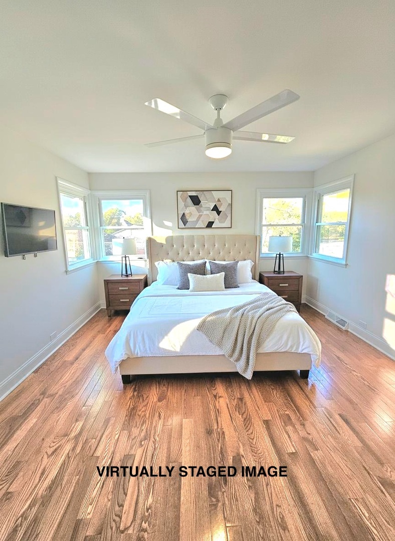 7434 Emerson Street Morton Grove, IL 60053 - Photo 14 of 43 a large bedroom with wooden floor bed and window