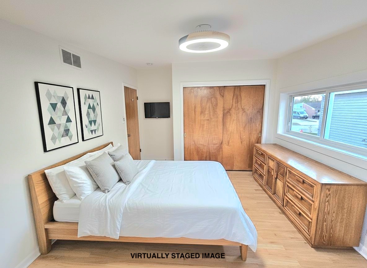 7434 Emerson Street Morton Grove, IL 60053 - Photo 20 of 43 a bed room with a bed and a window