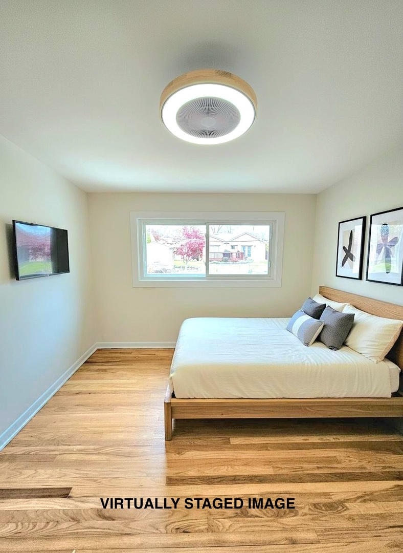 7434 Emerson Street Morton Grove, IL 60053 - Photo 22 of 43 a bedroom with a bed and a painting on the wall