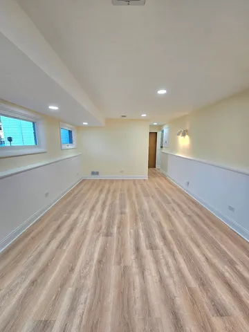 a bathroom with a toilet a sink a mirror and bathtub