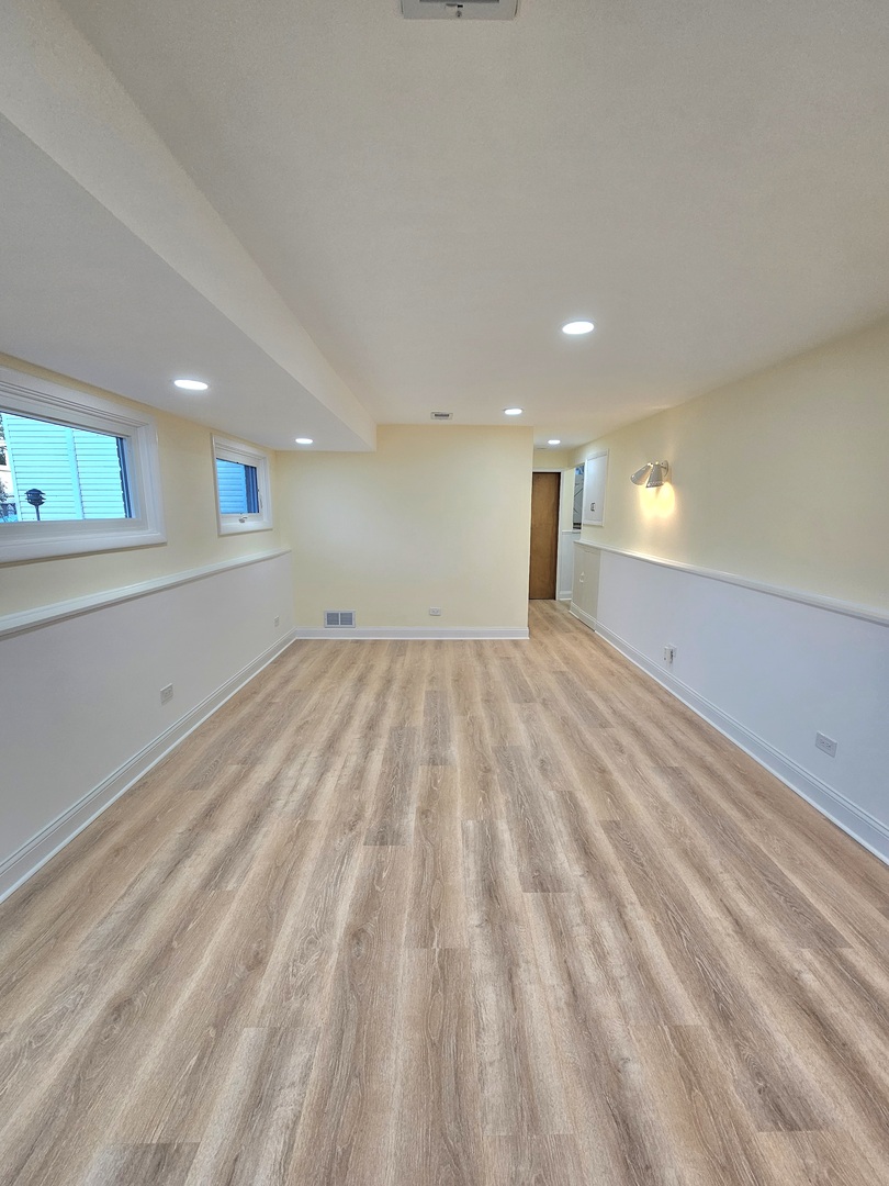 7434 Emerson Street Morton Grove, IL 60053 - Photo 28 of 43 a view of empty room with wooden floor