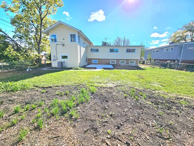a view of a house with a yard and a garage
