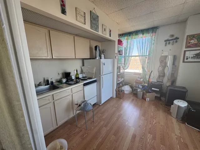 a kitchen with sink cabinets and wooden floor