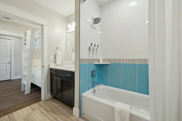 a bathroom with a bathtub and a sink