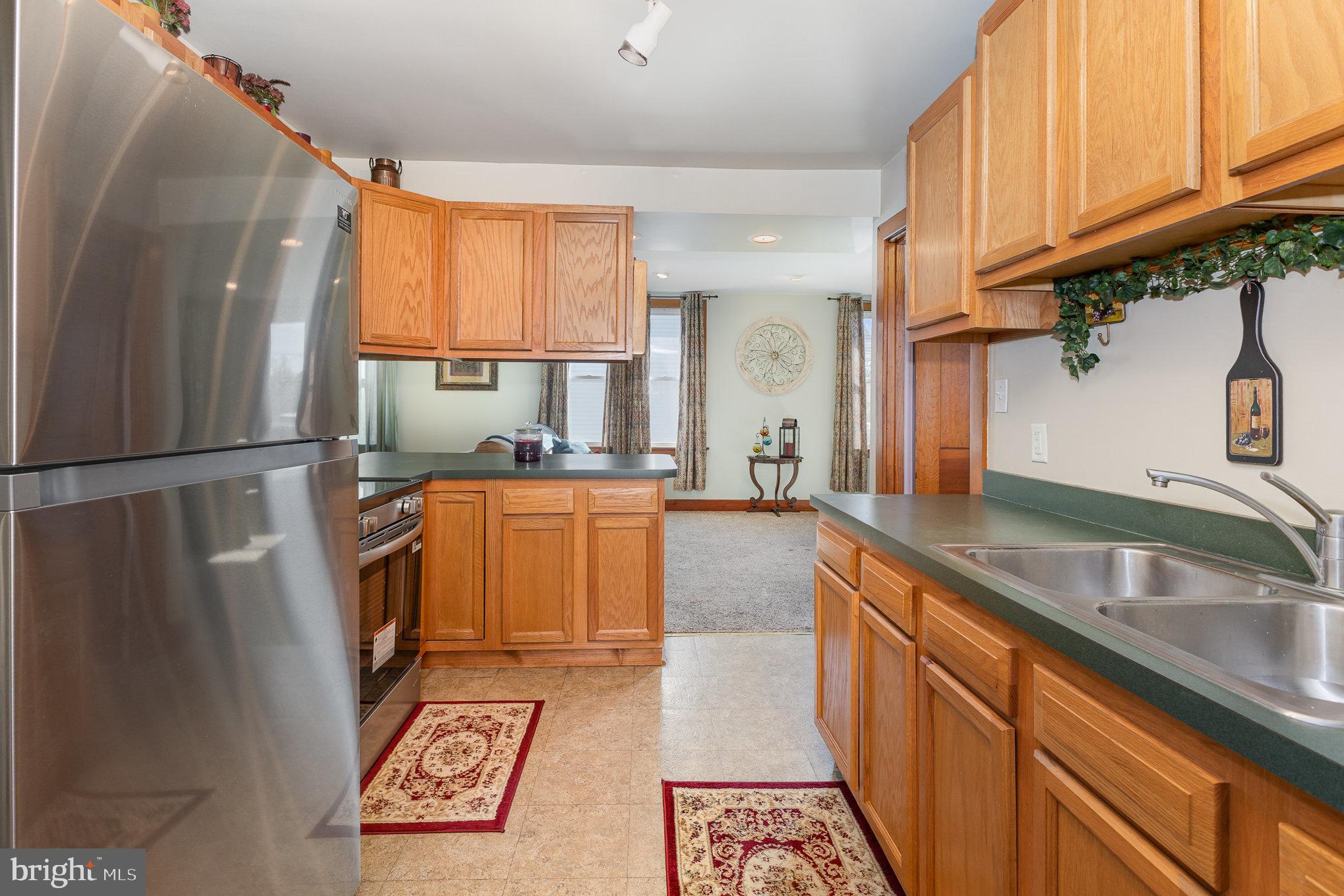 384 High Street Highspire, PA 17034 - Photo 14 of 35 a kitchen with granite countertop a refrigerator and a sink