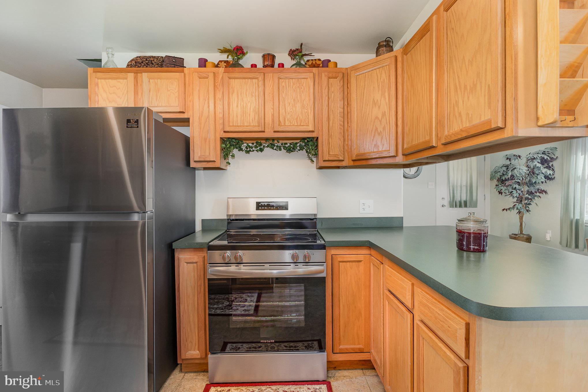 384 High Street Highspire, PA 17034 - Photo 17 of 35 a kitchen with stainless steel appliances a refrigerator a sink a stove and cabinets