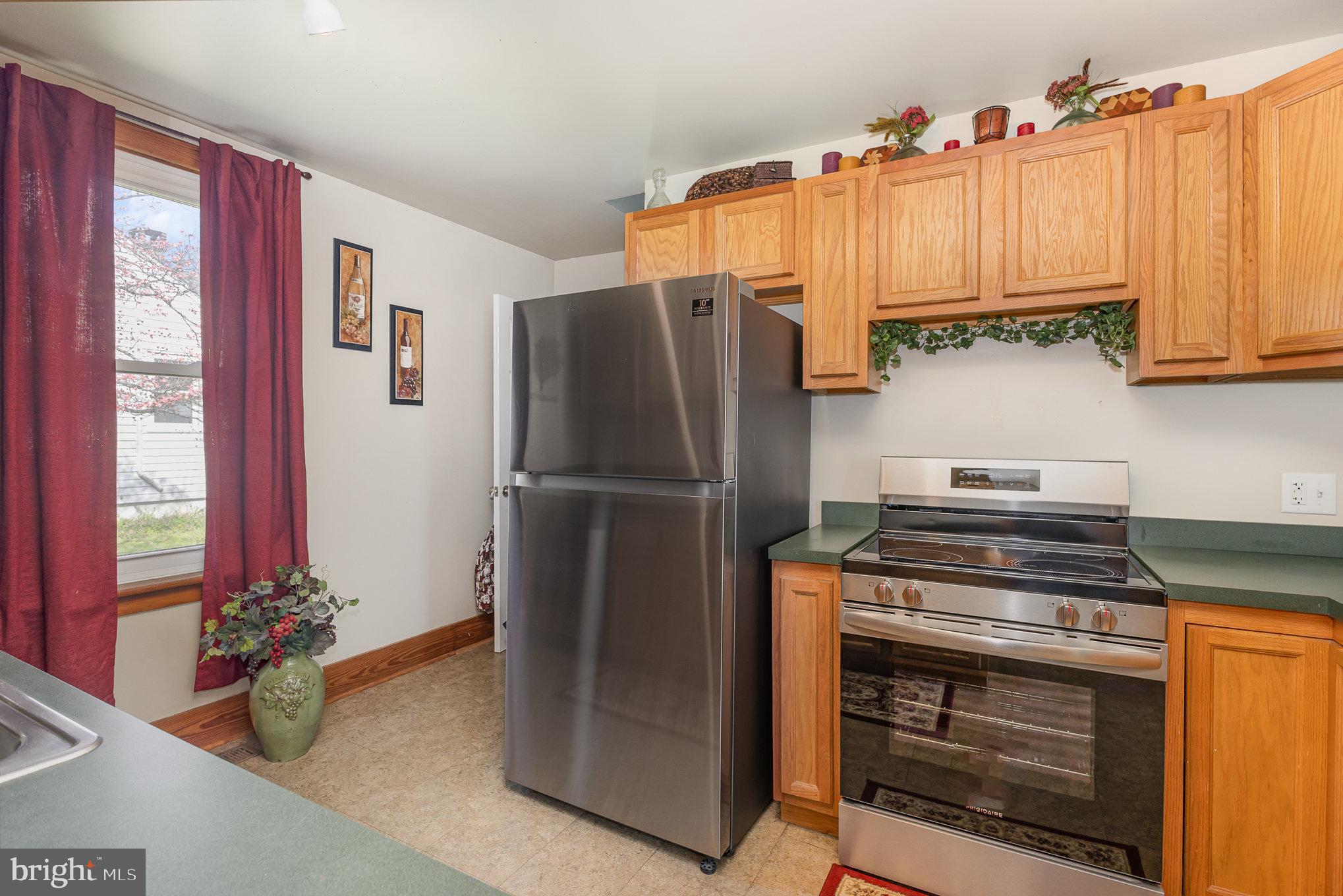 384 High Street Highspire, PA 17034 - Photo 18 of 35 a kitchen with wooden cabinets and stainless steel appliances