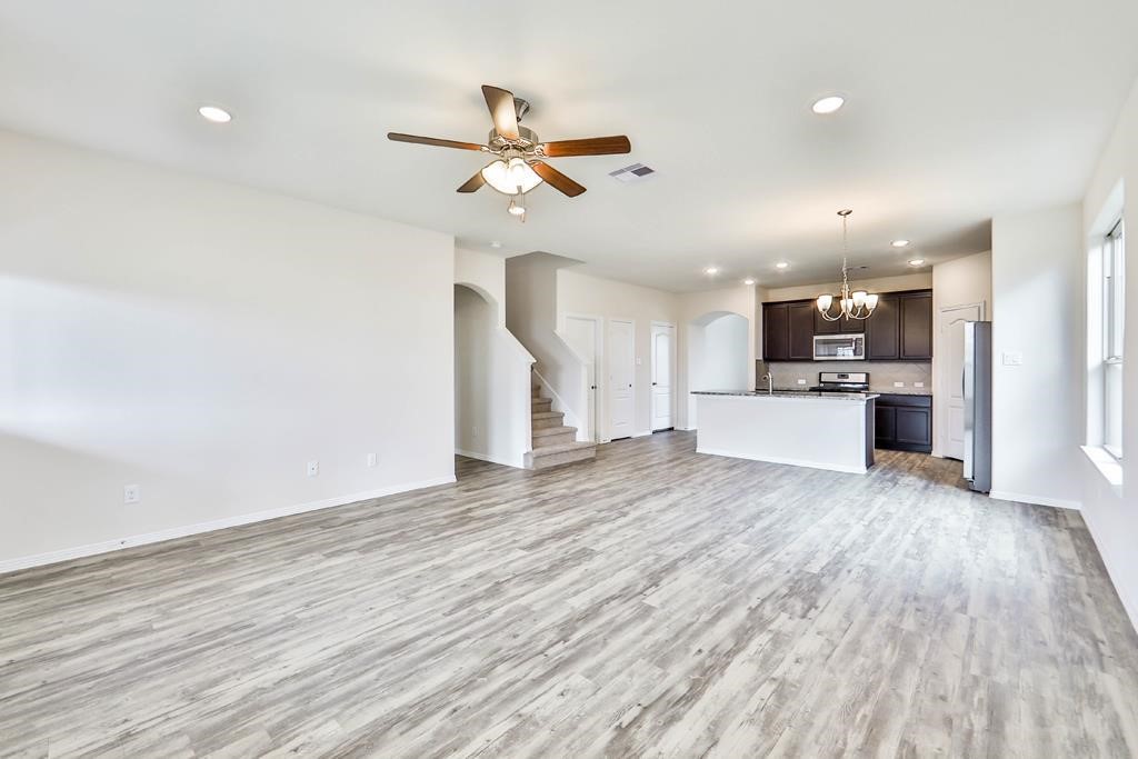 247 Sintra Lk Way Rosenberg, TX 77469 - Photo 5 of 28 a view of a kitchen with a sink and wooden floor