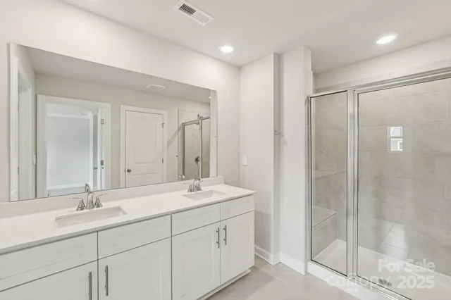 a bathroom with a granite countertop sink a toilet and shower