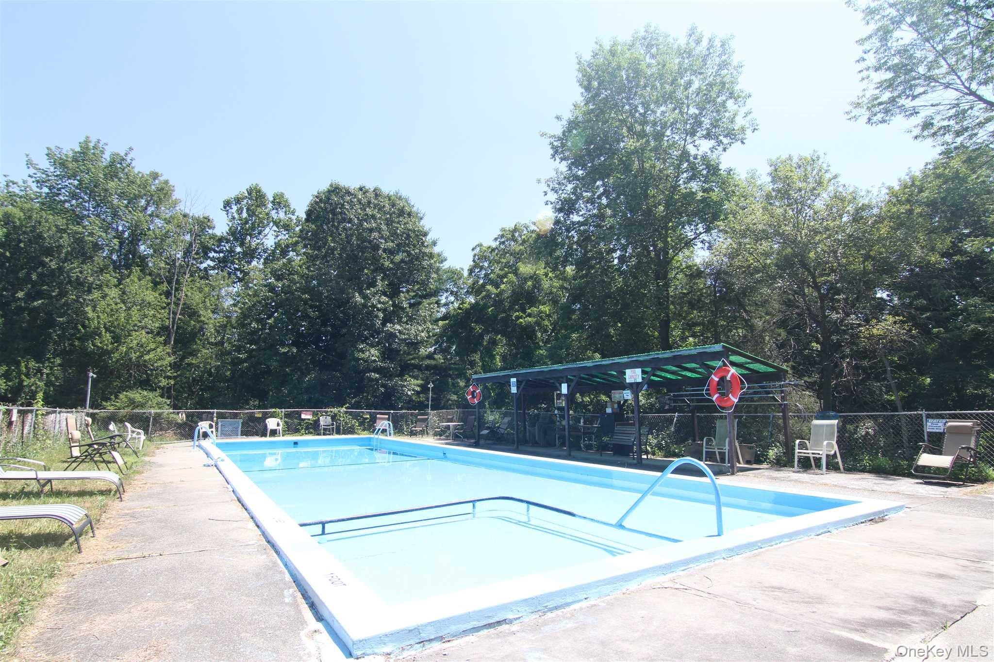 71 Miller Road, Unit 25 Hopewell Junction, NY 12533 - Photo 4 of 10 a house view with a sitting space and large trees