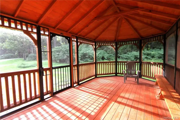 a balcony with wooden floor in outdoor space
