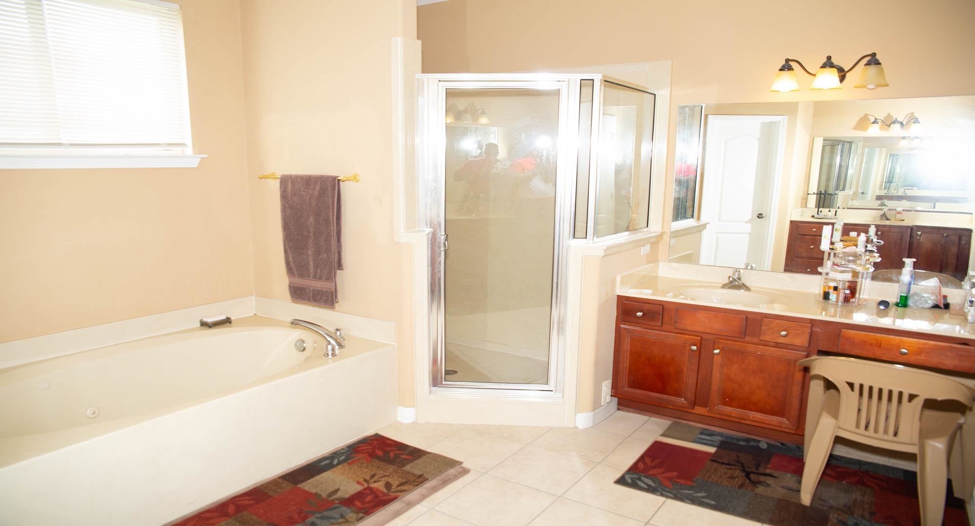 8483 Boothes Ridge Drive Memphis, TN 38125 - Photo 22 of 38 Full bath with a bath, vanity, tile patterned flooring, and a stall shower