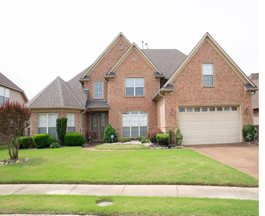 8483 Boothes Ridge Drive Memphis, TN 38125 - Photo 3 of 38 Traditional-style house with a shingled roof, brick siding, a garage, a front yard, and concrete driveway