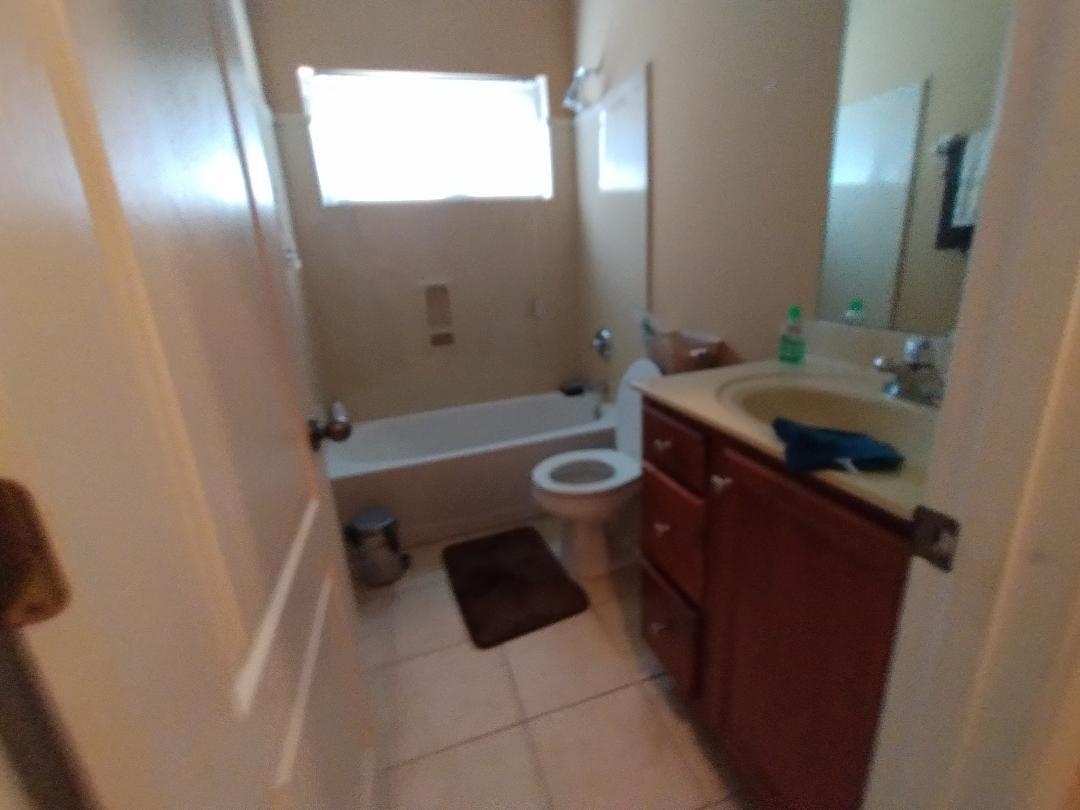 8483 Boothes Ridge Drive Memphis, TN 38125 - Photo 7 of 38 Full bath with toilet, tile patterned floors, vanity, and bathing tub / shower combination