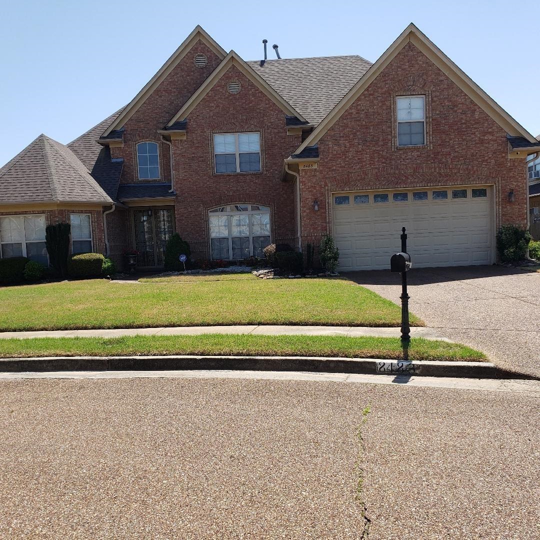 8483 Boothes Ridge Drive Memphis, TN 38125 - Photo 10 of 38 Traditional-style house with brick siding, an attached garage, driveway, and a front lawn