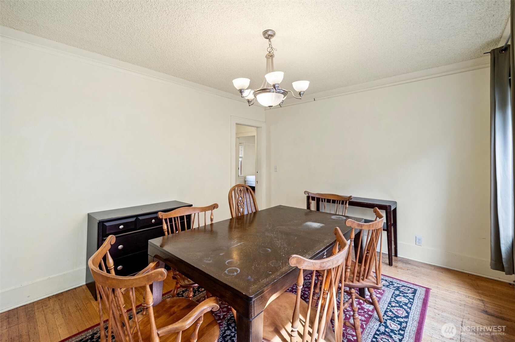5016 7th Avenue Northeast Seattle, WA 98105 - Photo 11 of 36 a view of a dining room with furniture and wooden floor