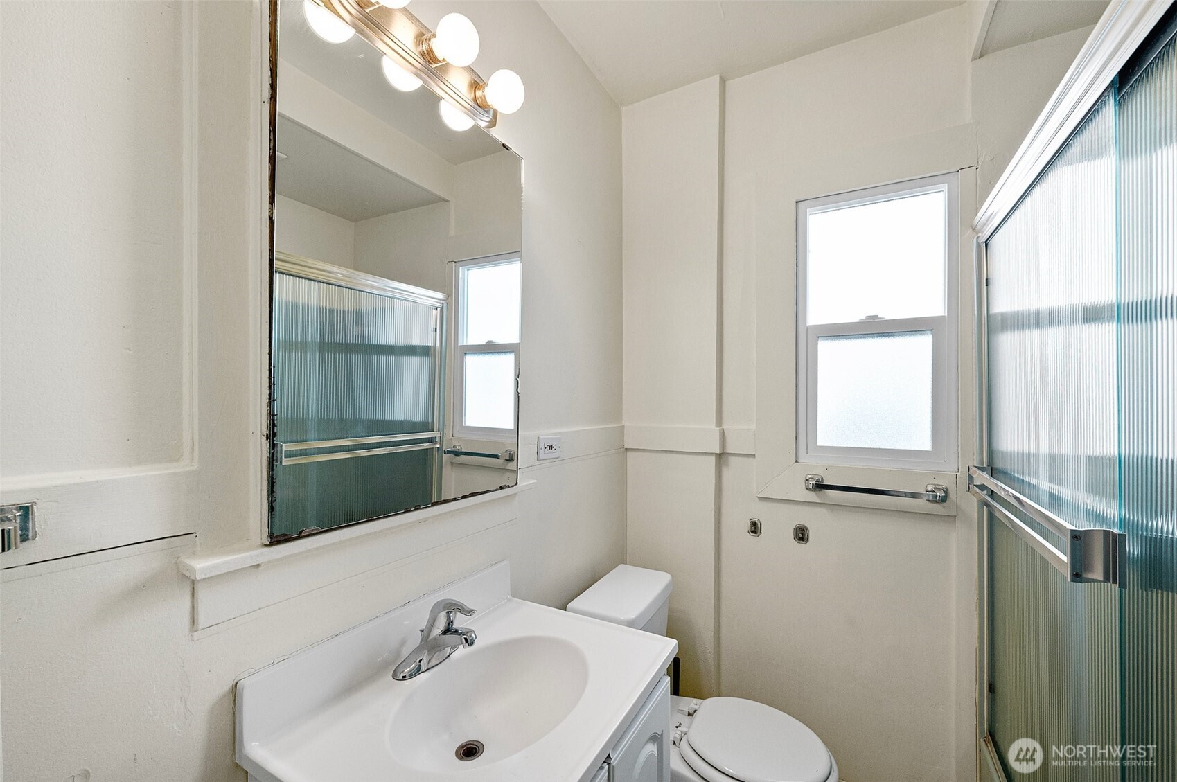 5016 7th Avenue Northeast Seattle, WA 98105 - Photo 12 of 36 a bathroom with a sink and mirror with toilet